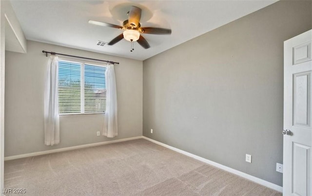 empty room with ceiling fan and light carpet