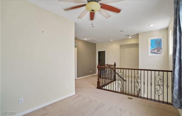 empty room with light colored carpet and ceiling fan