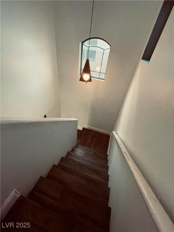 stairway with hardwood / wood-style floors