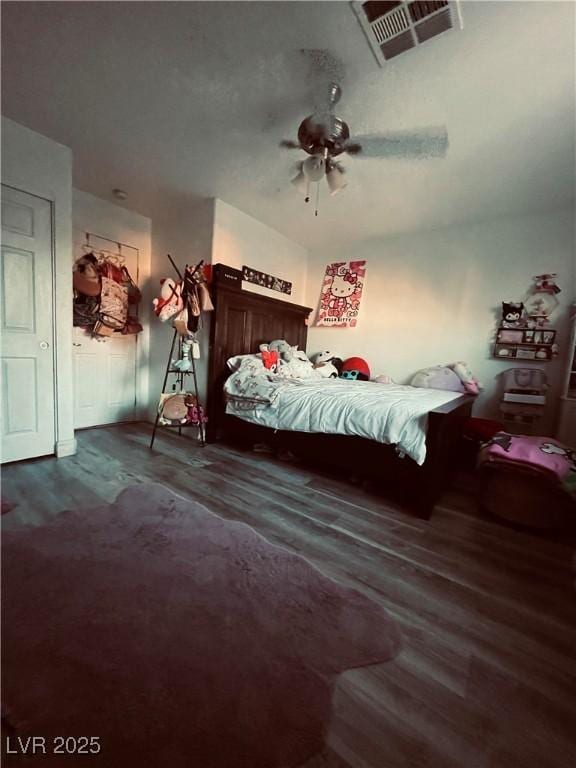 unfurnished bedroom featuring ceiling fan and dark hardwood / wood-style flooring