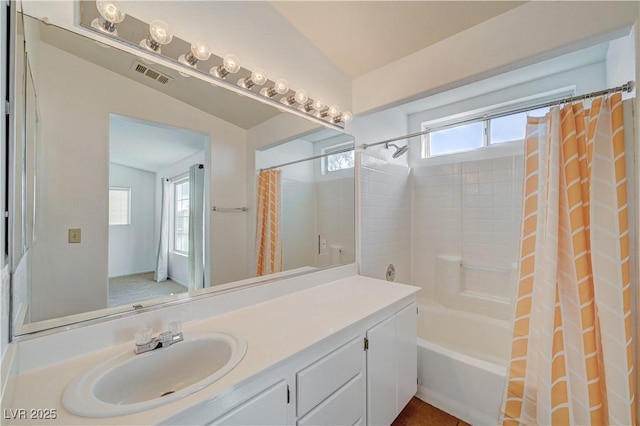 bathroom featuring vanity and shower / bathtub combination with curtain