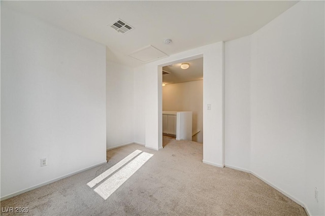 unfurnished room featuring light colored carpet