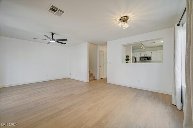 unfurnished living room featuring light hardwood / wood-style flooring and ceiling fan