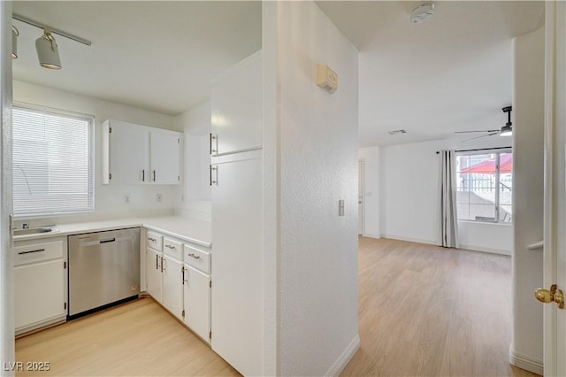 kitchen featuring white cabinetry, ceiling fan, dishwasher, and light wood-type flooring