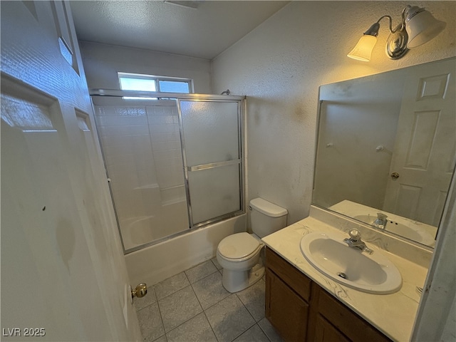 full bathroom featuring vanity, toilet, tile patterned flooring, and combined bath / shower with glass door