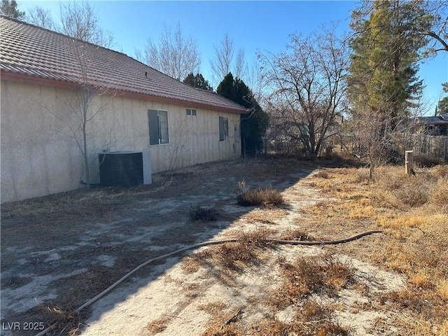 view of side of property featuring central AC unit