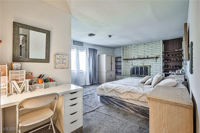 bedroom featuring dark colored carpet, a fireplace, and a textured ceiling