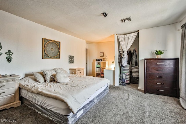 carpeted bedroom featuring a textured ceiling