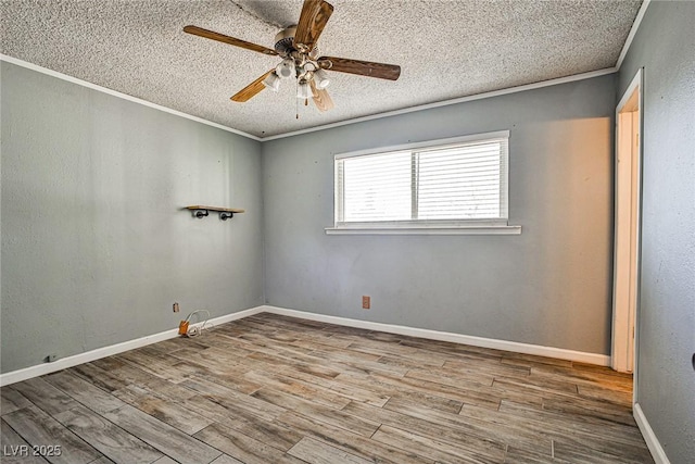 spare room with crown molding, ceiling fan, light hardwood / wood-style floors, and a textured ceiling