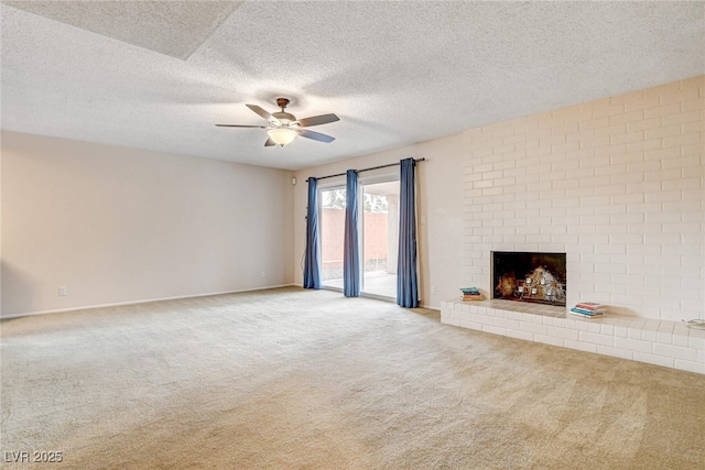 unfurnished living room featuring a brick fireplace, light colored carpet, a textured ceiling, and ceiling fan