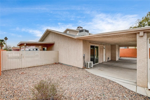 exterior space with ac unit and a patio