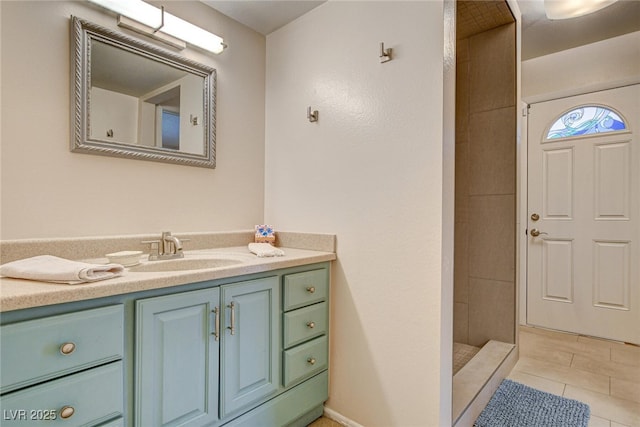 bathroom featuring tile patterned floors, vanity, and a shower