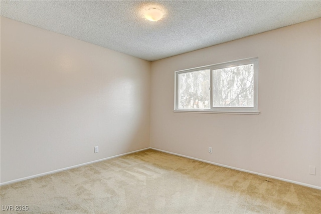 carpeted empty room with a textured ceiling