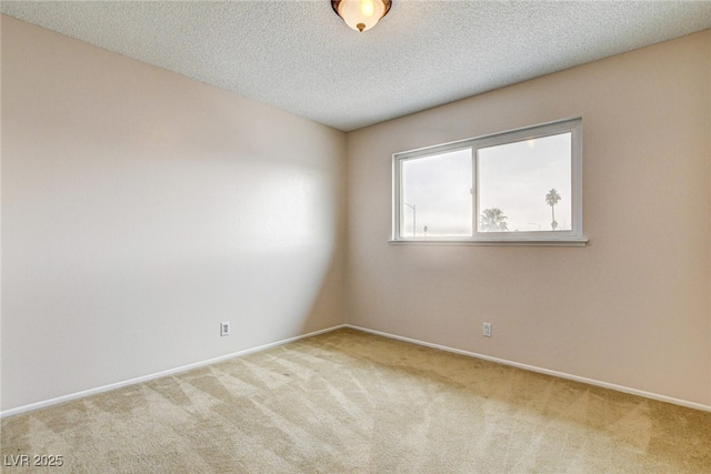 carpeted spare room with a textured ceiling