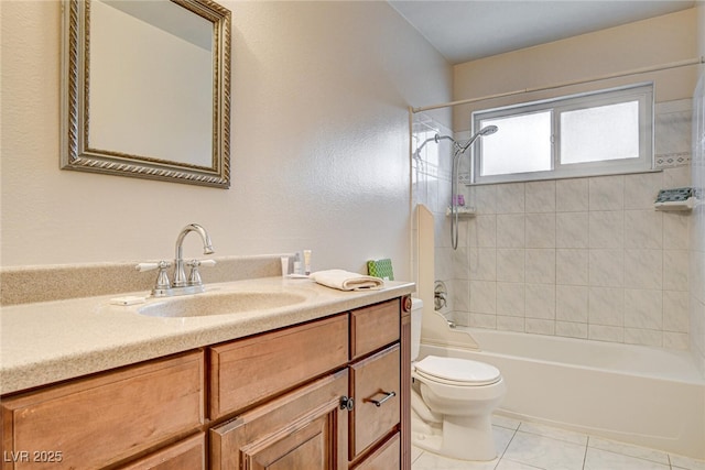 full bathroom with tile patterned flooring, tiled shower / bath, vanity, and toilet