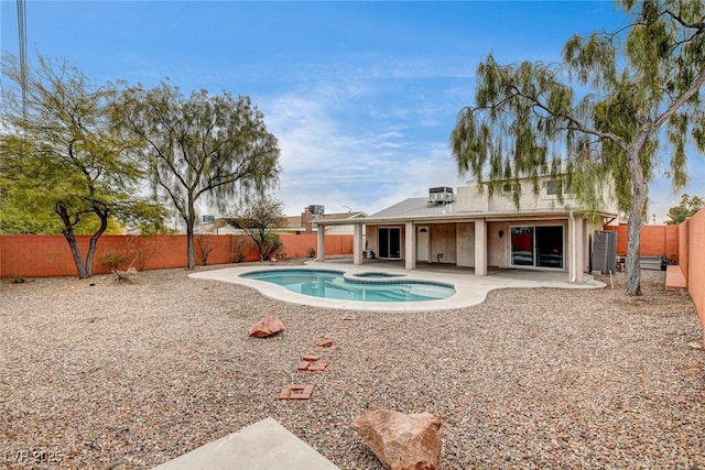 view of swimming pool with an in ground hot tub, central air condition unit, and a patio area