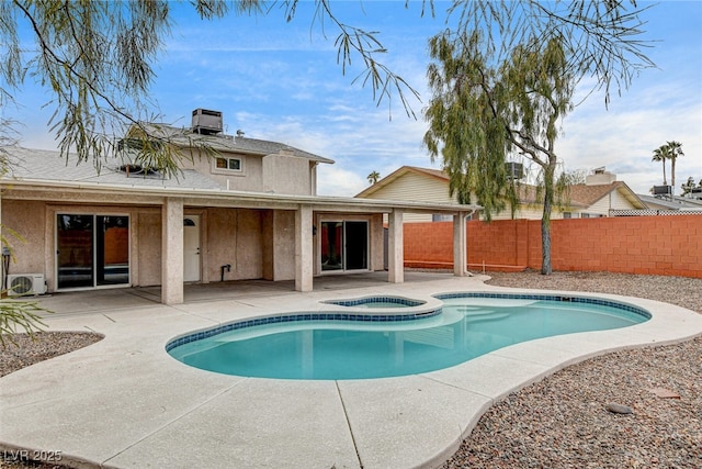 view of pool with an in ground hot tub, ac unit, cooling unit, and a patio area