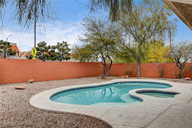 view of swimming pool featuring an in ground hot tub