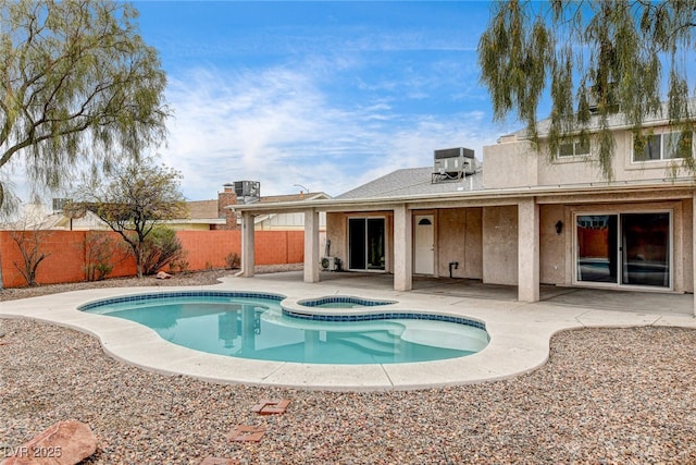 view of swimming pool with an in ground hot tub, central AC, and a patio area