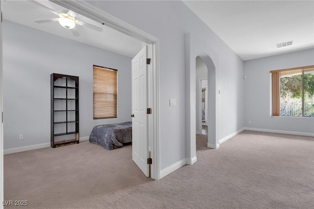 unfurnished bedroom with ceiling fan and light carpet