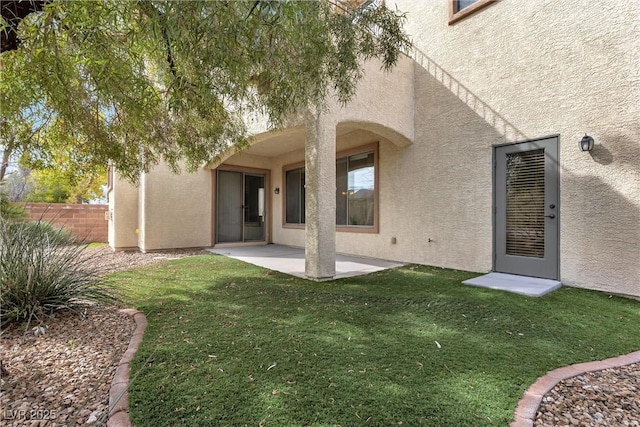 rear view of house with a patio area and a lawn