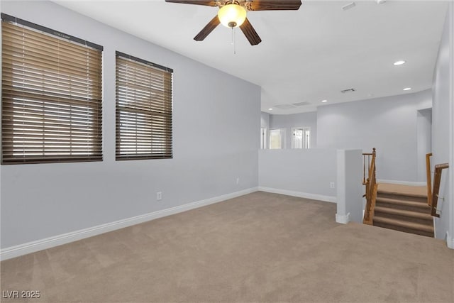 carpeted spare room with ceiling fan