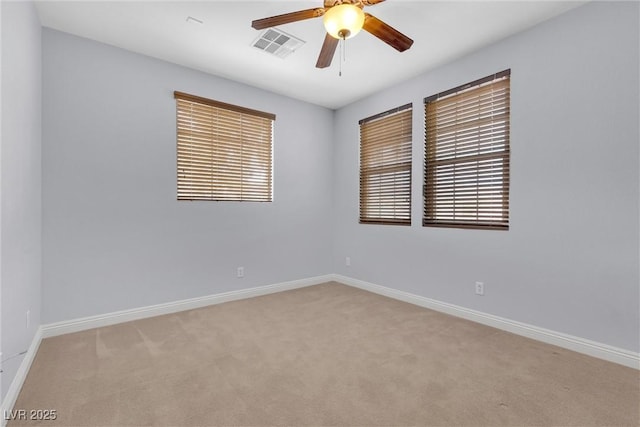 unfurnished room featuring light carpet and ceiling fan