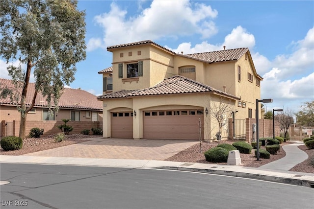 mediterranean / spanish home with a garage