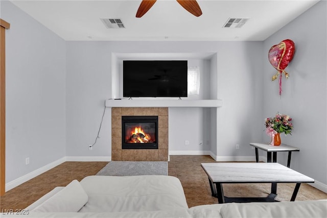 living room with ceiling fan and a fireplace