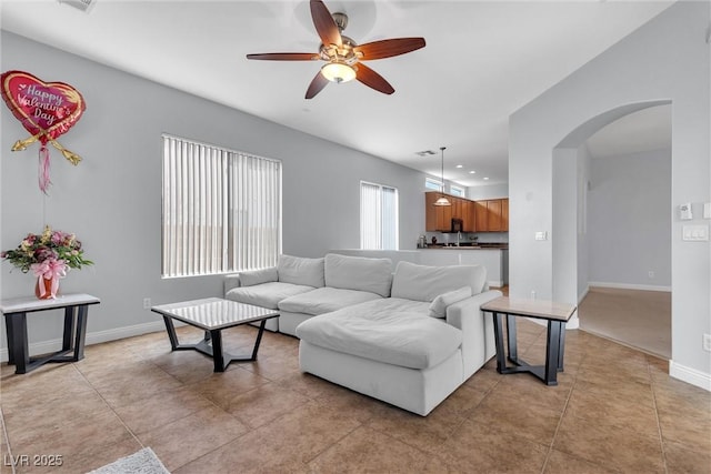 living room with light tile patterned floors and ceiling fan