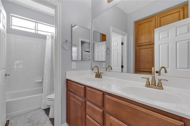 full bathroom with shower / bath combination with curtain, vanity, and toilet