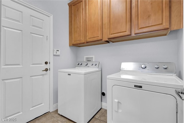 laundry room featuring cabinets and washer and dryer