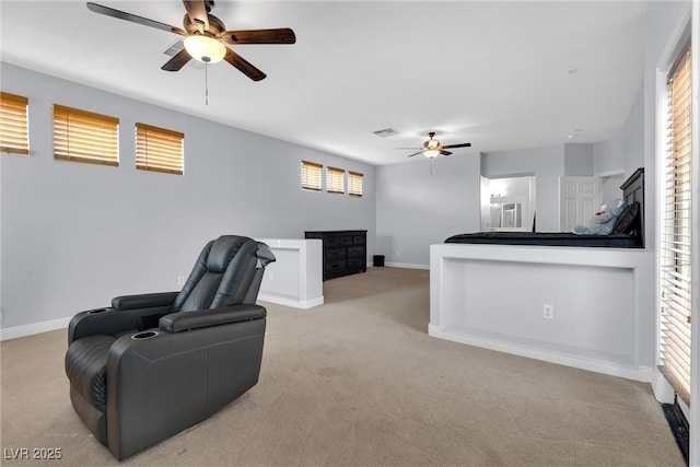 interior space featuring ceiling fan and light carpet