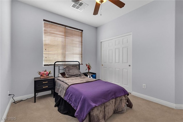 bedroom with light colored carpet, a closet, and ceiling fan