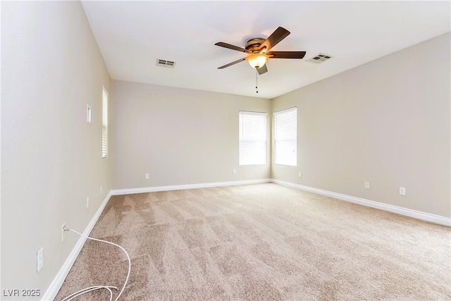 empty room featuring ceiling fan and carpet