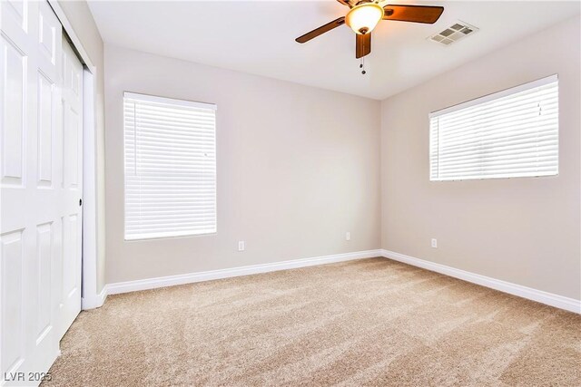 unfurnished bedroom featuring ceiling fan, carpet floors, and a closet