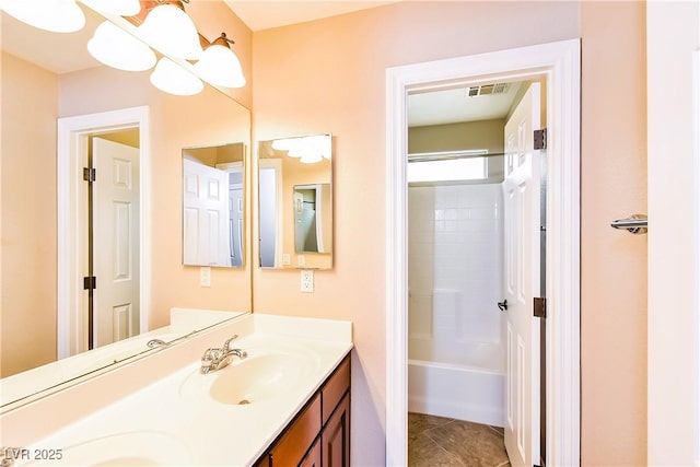 bathroom featuring tile patterned flooring, vanity, and tub / shower combination