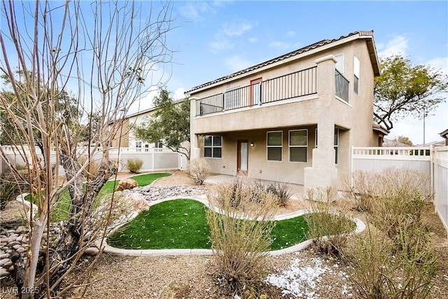 back of property with a balcony