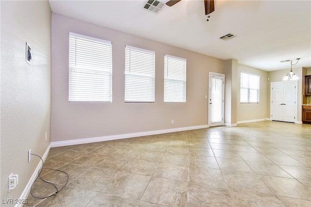 empty room featuring light tile patterned floors and ceiling fan