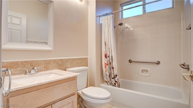 full bathroom featuring toilet, vanity, and shower / bath combo with shower curtain