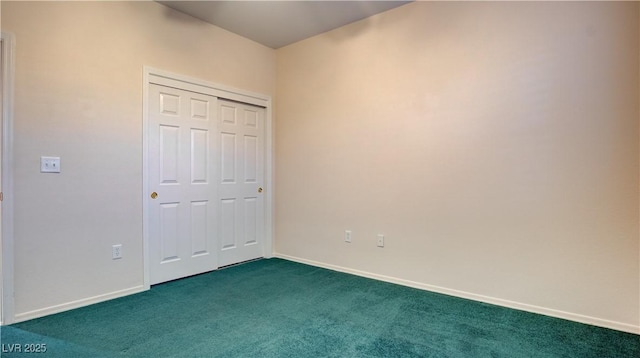 unfurnished bedroom with dark carpet and a closet