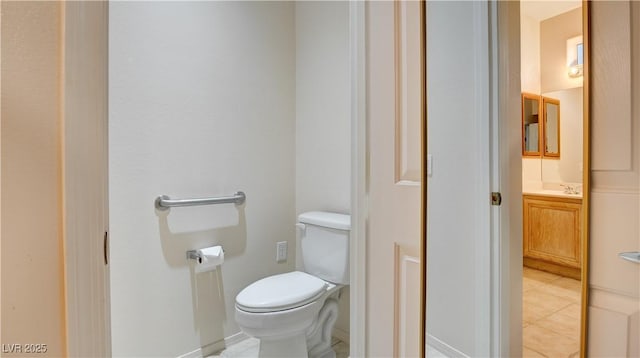 bathroom featuring tile patterned floors, vanity, and toilet