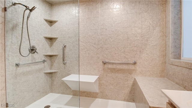 bathroom with vanity and tiled shower