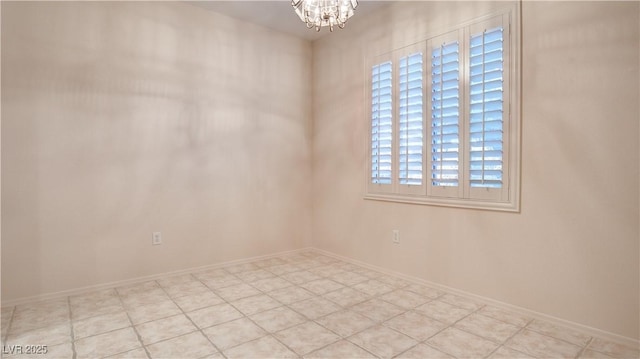 spare room featuring an inviting chandelier