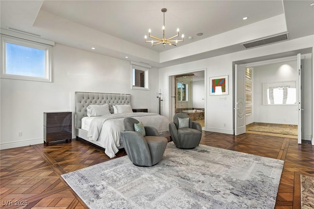 bedroom featuring a notable chandelier, a tray ceiling, and dark parquet floors