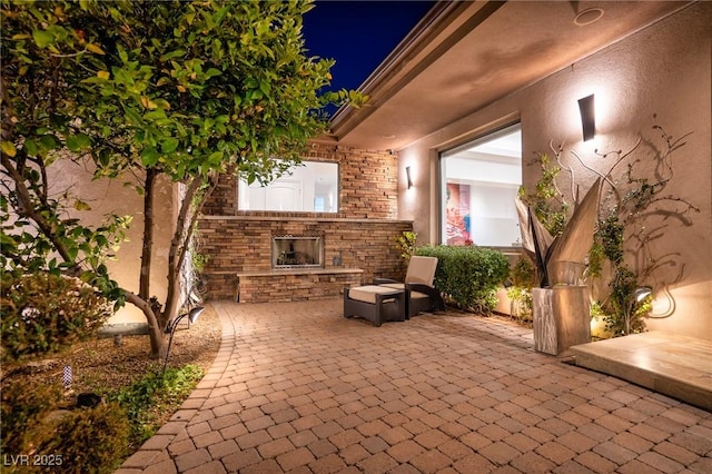 view of patio / terrace featuring an outdoor stone fireplace