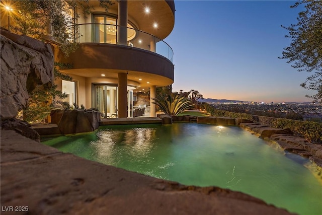 view of pool at dusk