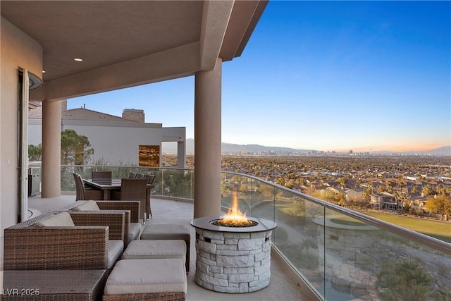 balcony at dusk with a mountain view and a fire pit