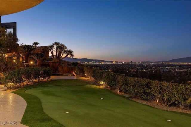 yard at dusk featuring a mountain view