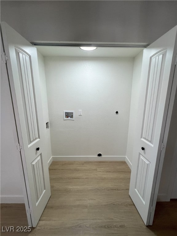 laundry area featuring hookup for a washing machine and light hardwood / wood-style floors